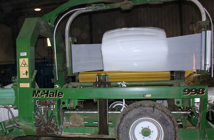 Compressed Sweet Hay bale being wrapped for shipment.